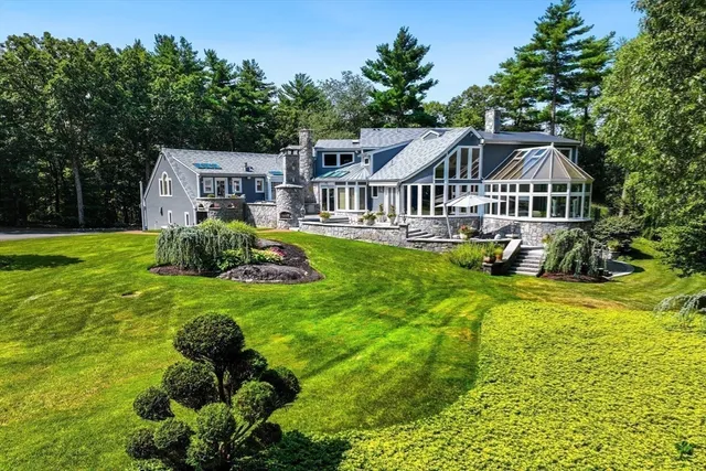 a house with a big yard and large trees