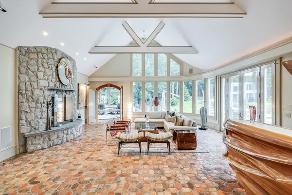 a living room with furniture and large windows