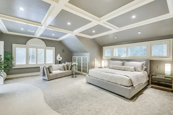 a large bedroom with a large bed and a large window