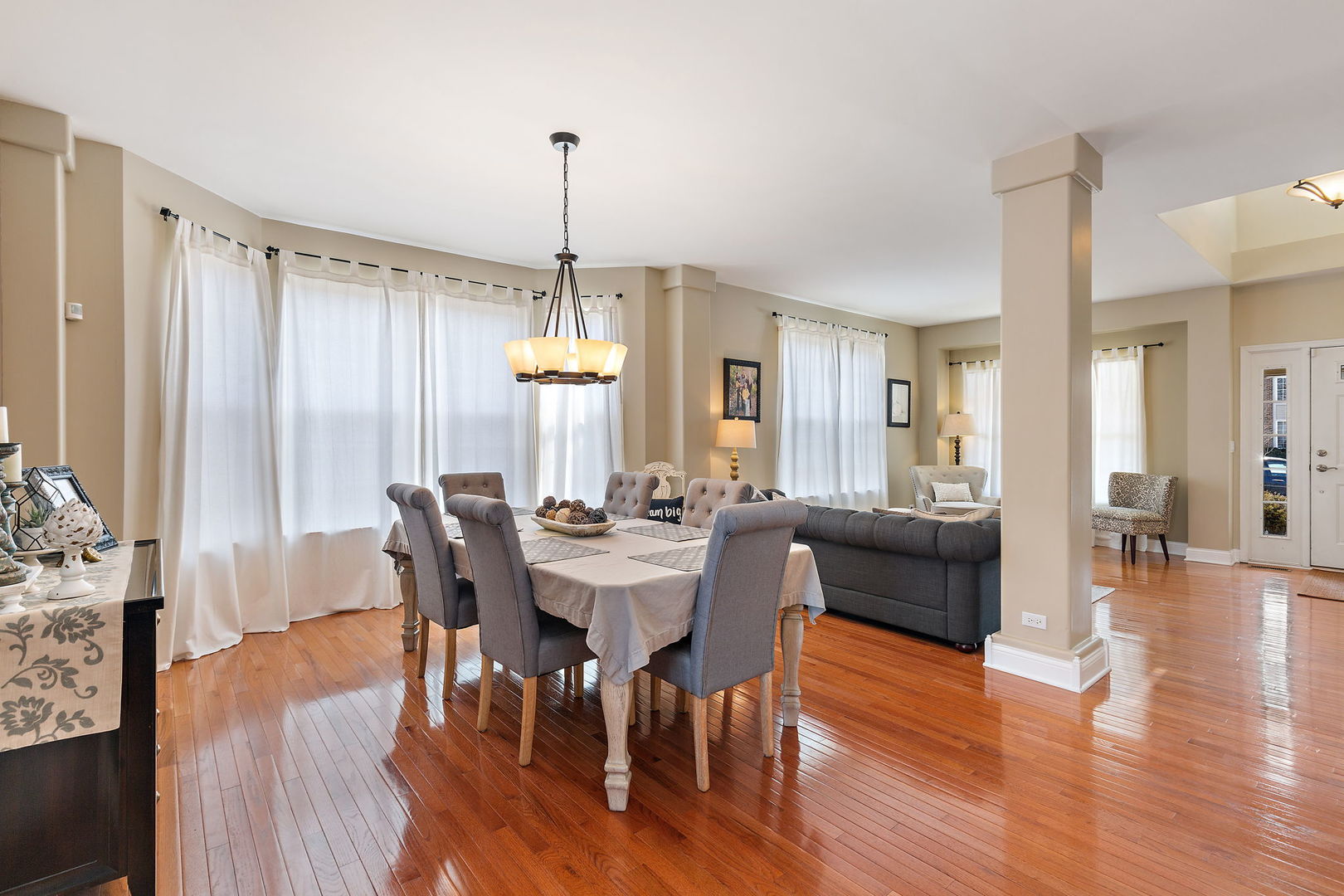 1502 Summerhill Lane Cary, IL 60013 - Photo 4 of 17 a view of a a dining room and livingroom with furniture wooden floor a chandelier
