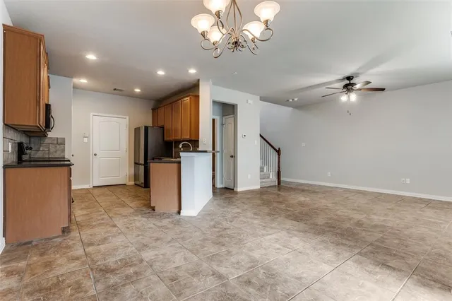 a view of a kitchen with a sink and a refrigerator