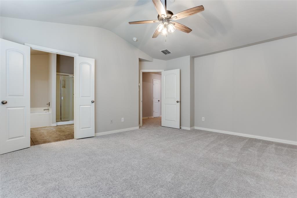 2288 Fletcher Trail Plano, TX 75025 - Photo 17 of 25 Unfurnished bedroom with light carpet, lofted ceiling, a ceiling fan, and connected bathroom
