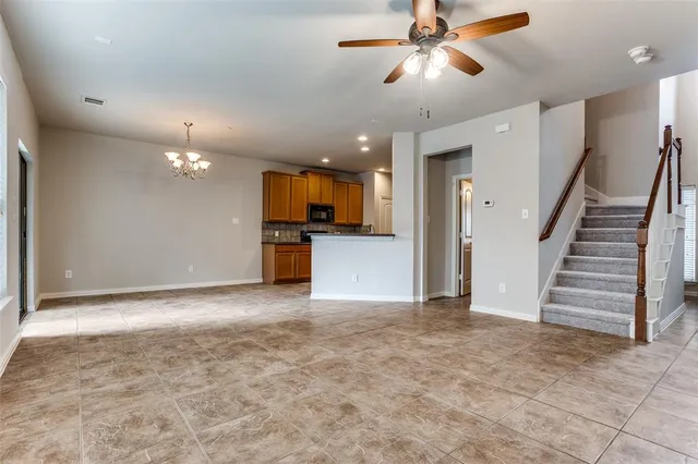 a view of a kitchen with a sink and a kitchen island