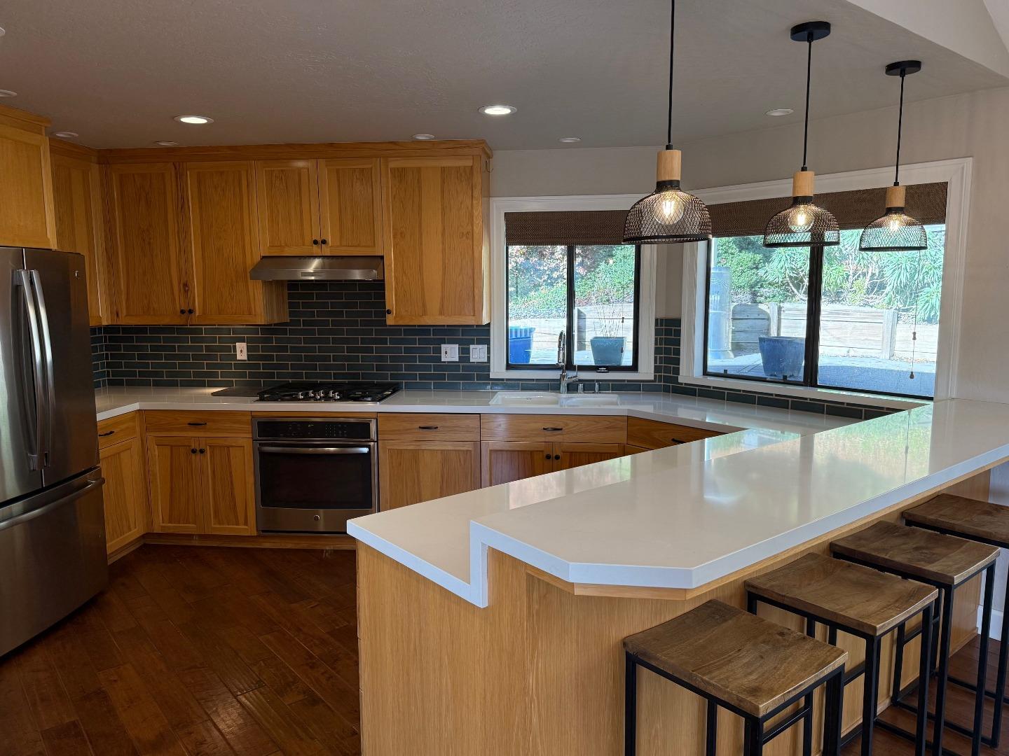 10 Fred Court Scotts Valley, CA 95066 - Photo 3 of 7 a kitchen with stainless steel appliances granite countertop a sink a stove and a refrigerator