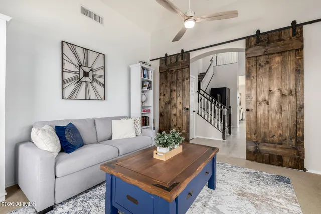 a living room with furniture and white walls