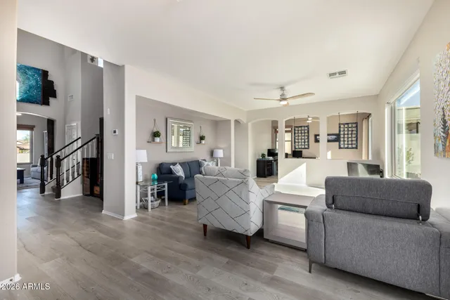 a kitchen with granite countertop a sink a stove top oven a counter space cabinetry and appliances