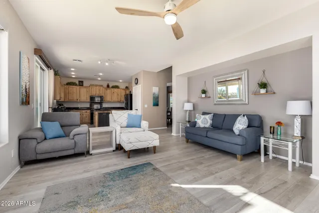 a kitchen with stainless steel appliances granite countertop a refrigerator a stove and a sink with wooden floor