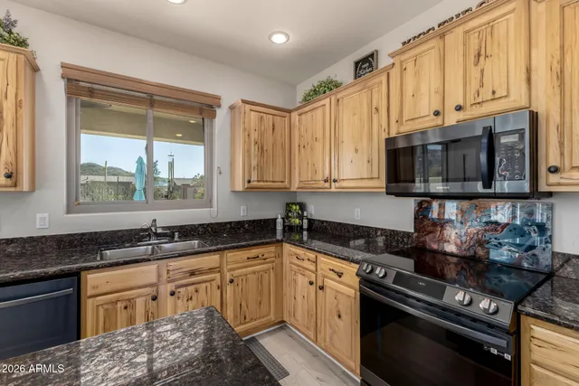 a bathroom with double vanity sink a two mirror a window and a shower