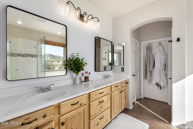a view of a swimming pool with a lounge chairs and potted plants