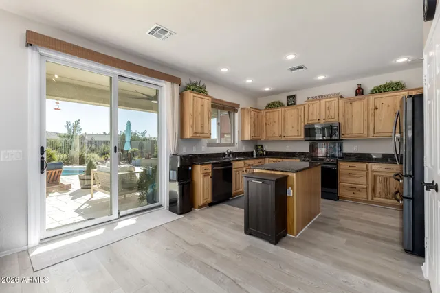a view of staircase with wooden floor and a front door