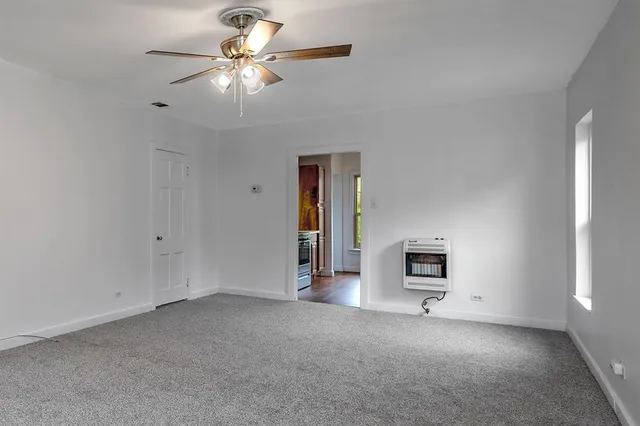 a view of a livingroom with a chandelier fan
