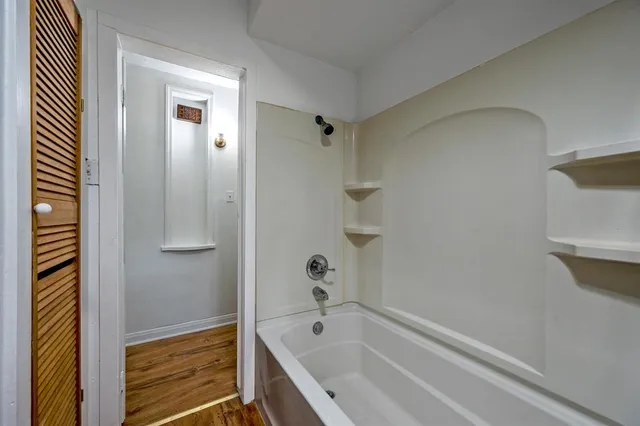 a bathroom with a tub and shower