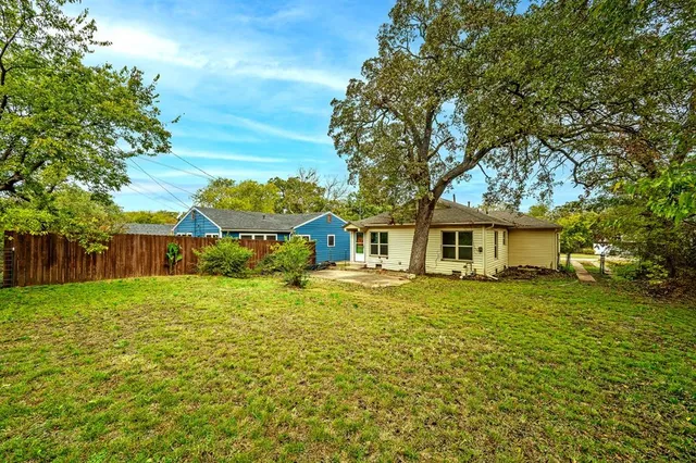 a front view of a house with yard and green space