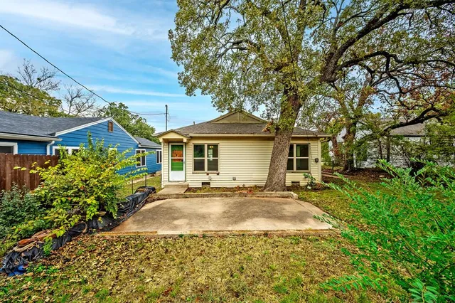 a front view of a house with a garden and yard