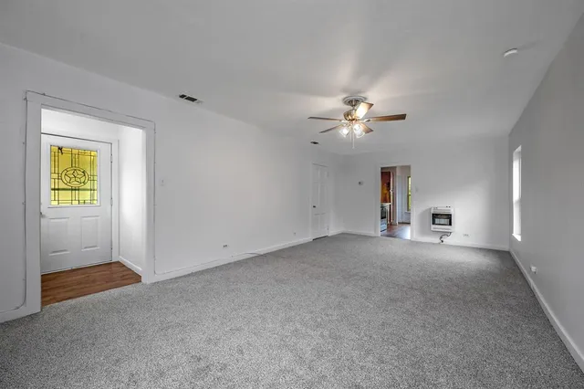 a view of a livingroom with a ceiling fan and window