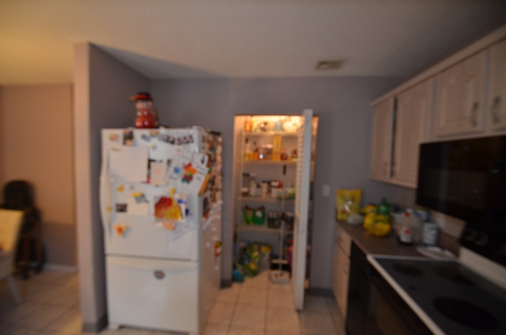 2 Rocky Nook, Unit 2 Malden, MA 02148 - Photo 11 of 27 a refrigerator freezer sitting inside of a kitchen