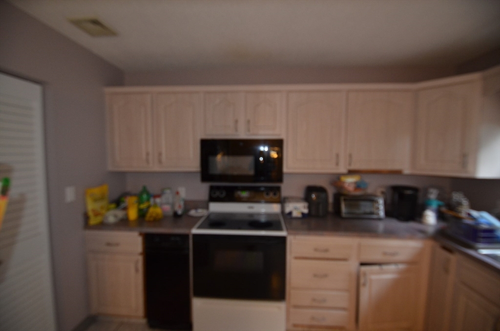 2 Rocky Nook, Unit 2 Malden, MA 02148 - Photo 12 of 27 a kitchen with a sink stainless steel appliances and cabinets