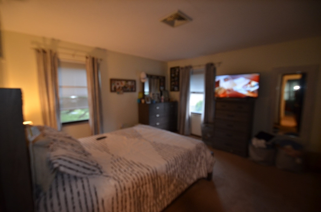 2 Rocky Nook, Unit 2 Malden, MA 02148 - Photo 15 of 27 a bedroom with a bed and a television