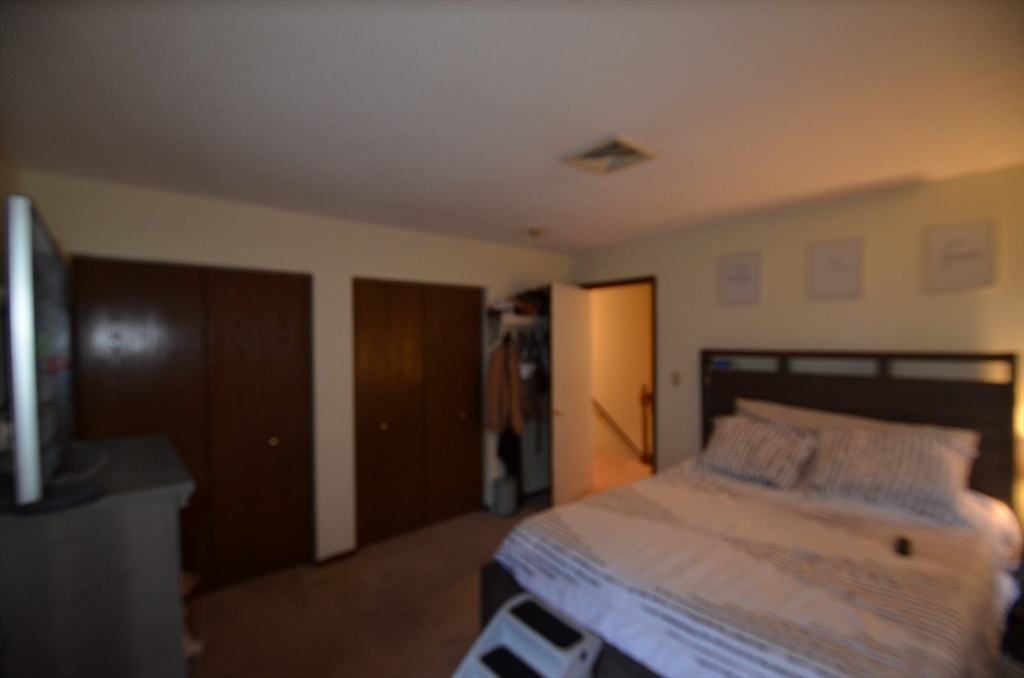 2 Rocky Nook, Unit 2 Malden, MA 02148 - Photo 16 of 27 a bedroom with a bed and a mirror