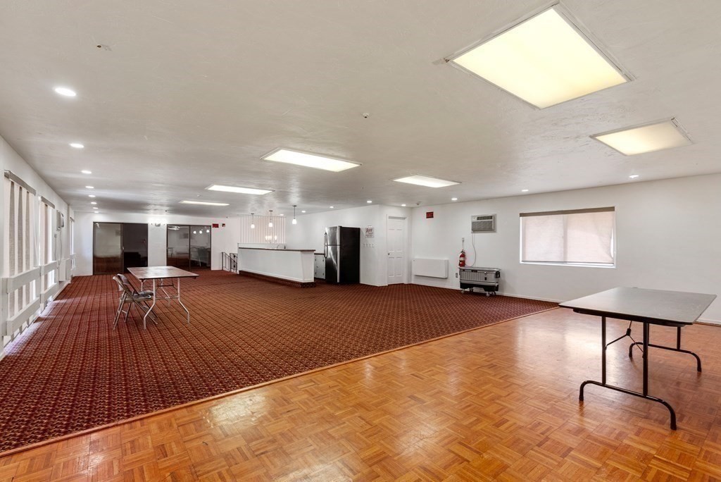 2 Rocky Nook, Unit 2 Malden, MA 02148 - Photo 25 of 27 a living room with furniture a wooden floor and next to a window