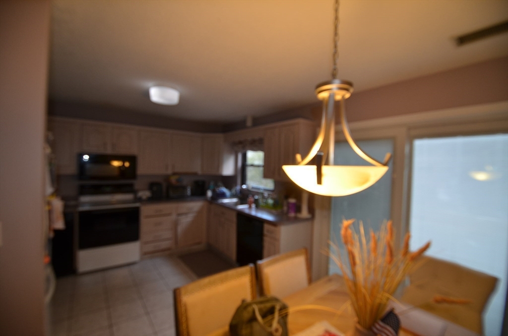 2 Rocky Nook, Unit 2 Malden, MA 02148 - Photo 8 of 27 a kitchen with stainless steel appliances granite countertop a sink a stove and a wooden floors