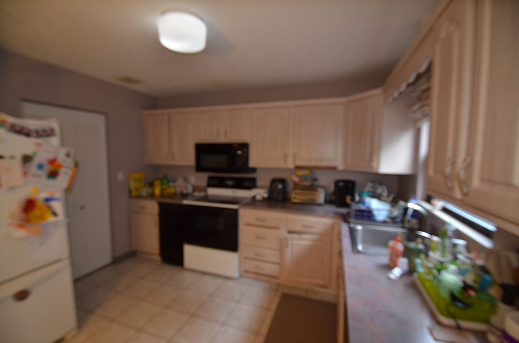 2 Rocky Nook, Unit 2 Malden, MA 02148 - Photo 10 of 27 a kitchen with a refrigerator and a stove top oven