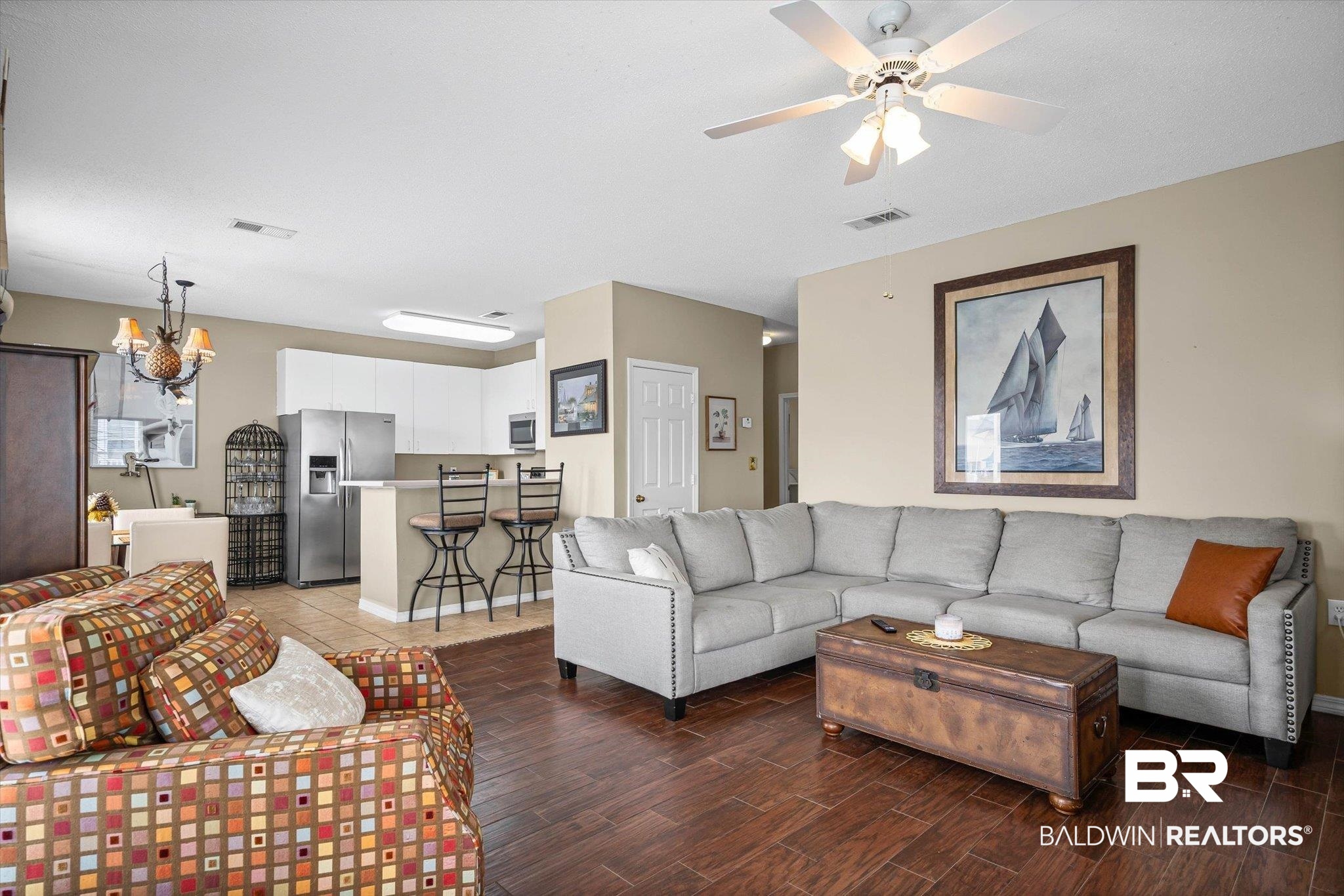 3575 Bayou Road, Unit B2 Orange Beach, AL 36561 - Photo 5 of 35 Living room featuring suspended lighting, dark wood-style flooring, and ceiling fan