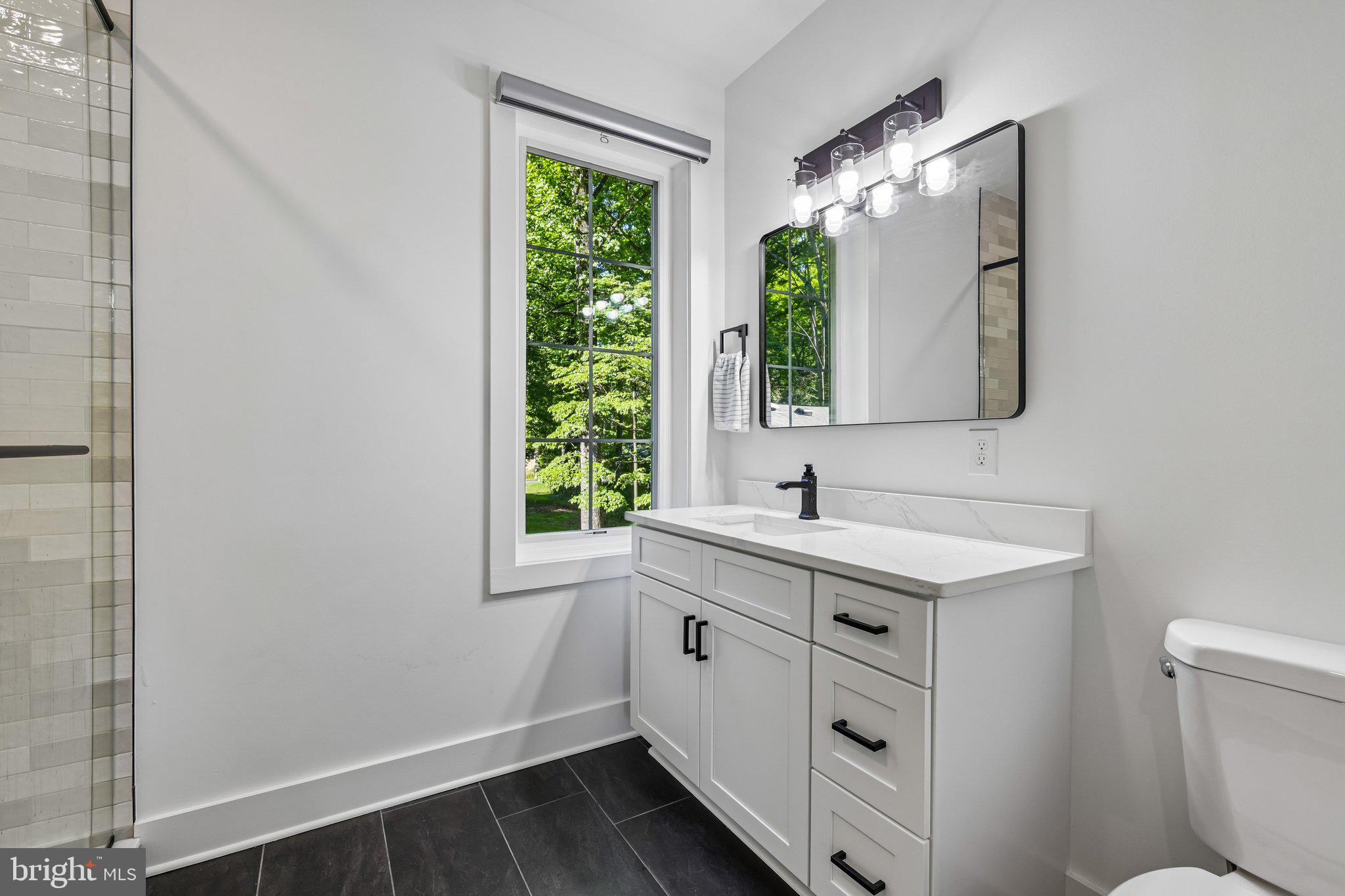 4315 Pinetree Road Rockville, MD 20853 - Photo 16 of 28 a bathroom with a sink and a mirror