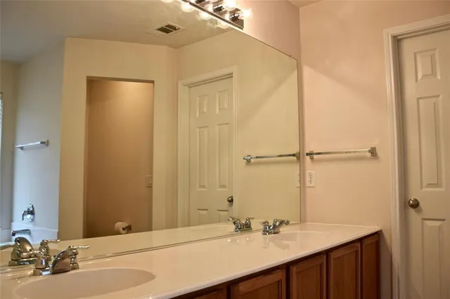 a bathroom with a glass shower door