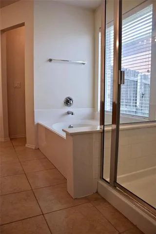 a bathroom with bathtub and window