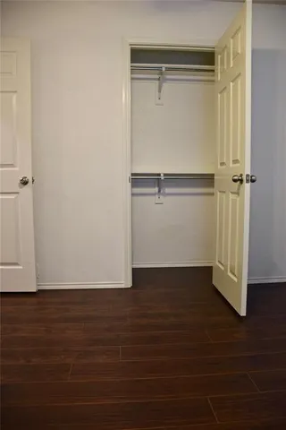 a front view of a house with a garden and yard