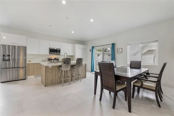 a kitchen with stainless steel appliances a sink stove top oven and cabinets