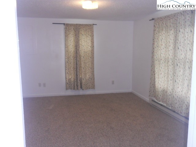 196 Boyden Road Banner Elk, NC 28604 - Photo 6 of 12 a view of an empty room with window