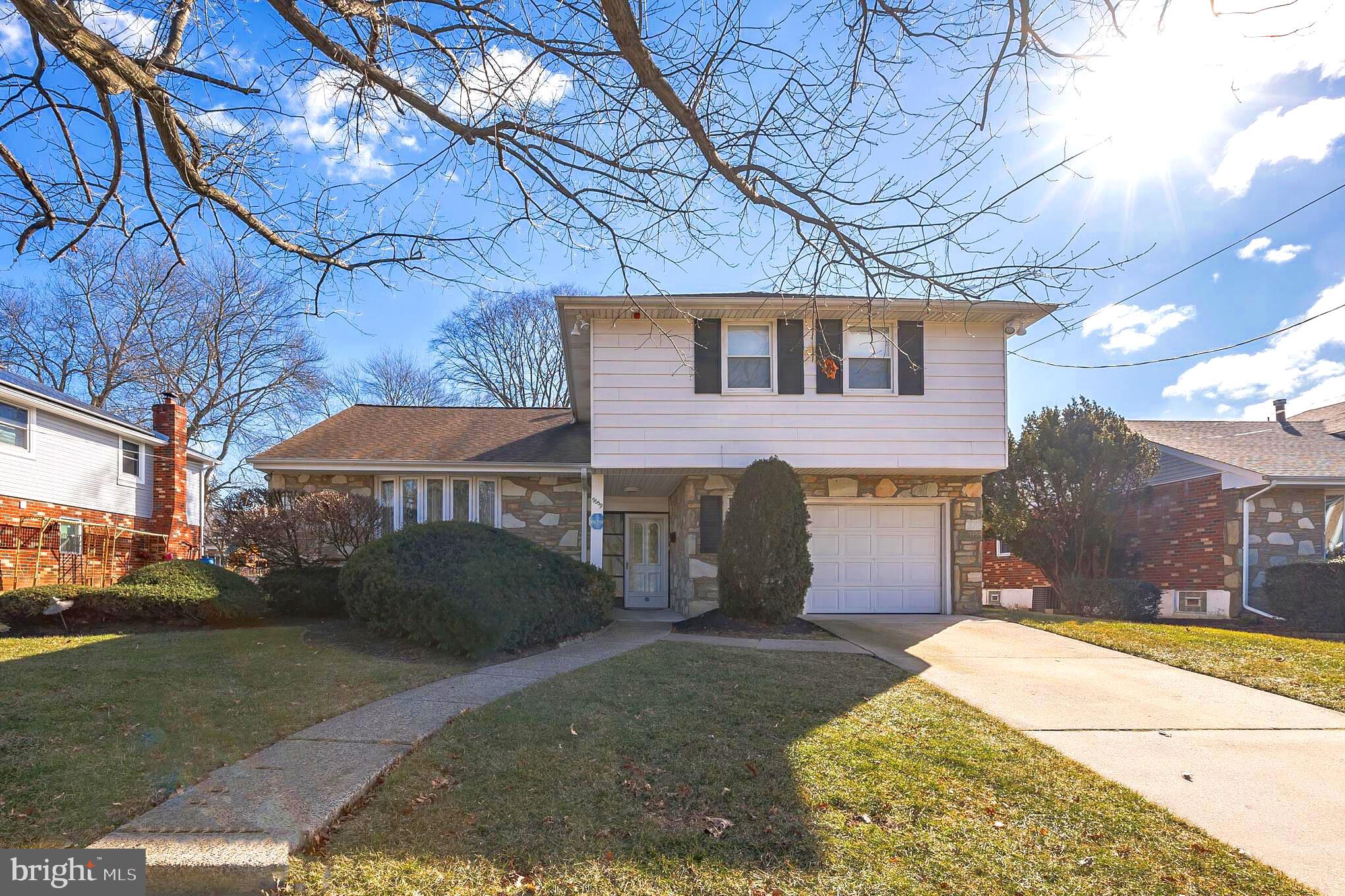 9659 Pine Road Philadelphia, PA 19115 - Photo 1 of 27 a front view of a house with a yard and garage