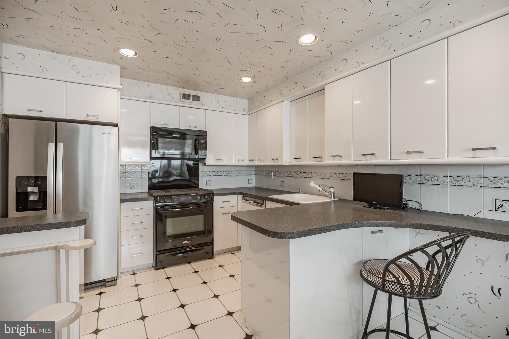 9659 Pine Road Philadelphia, PA 19115 - Photo 12 of 27 a kitchen with granite countertop a stove a sink and a refrigerator