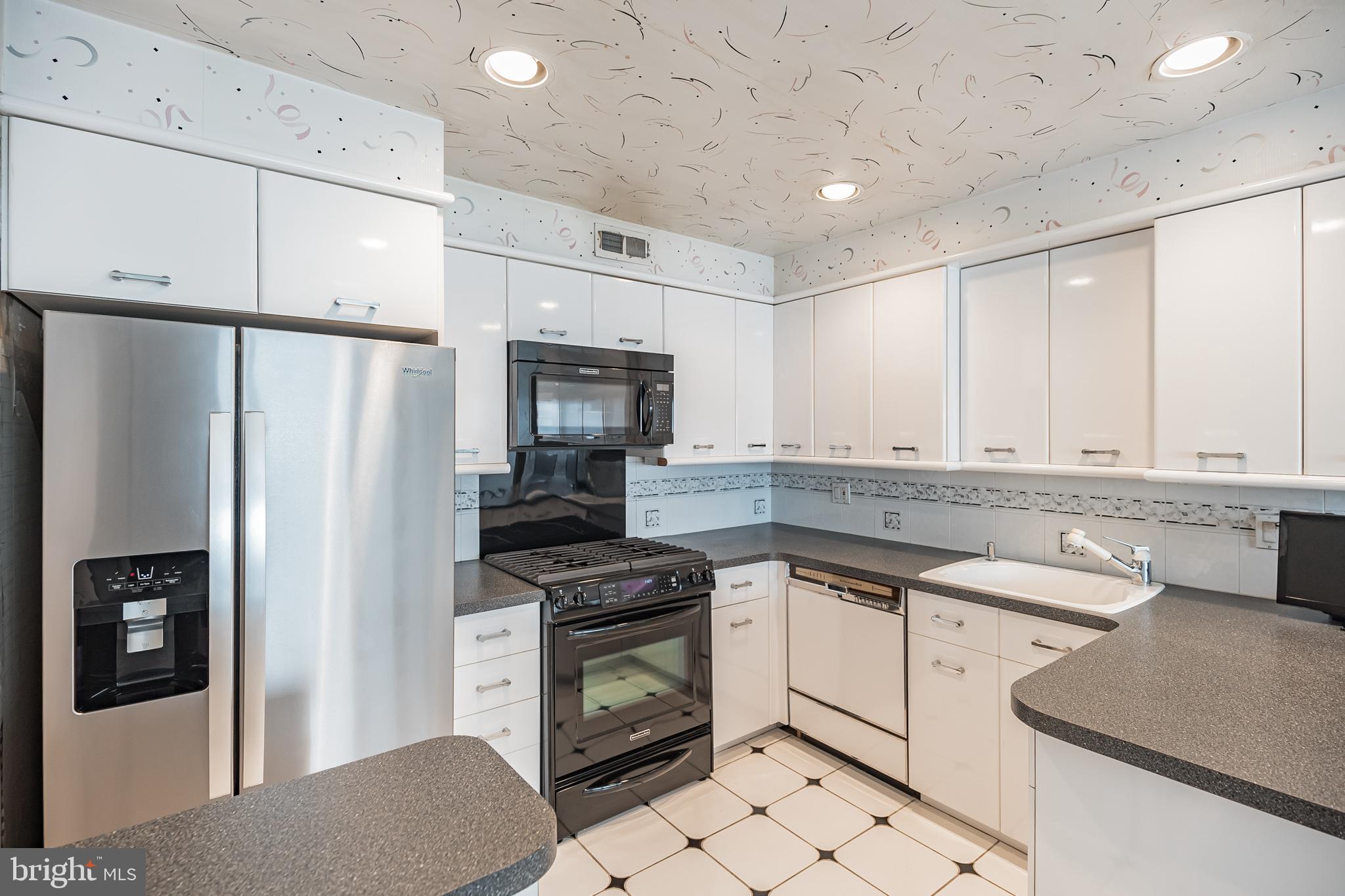 9659 Pine Road Philadelphia, PA 19115 - Photo 14 of 27 a kitchen with white cabinets and stainless steel appliances