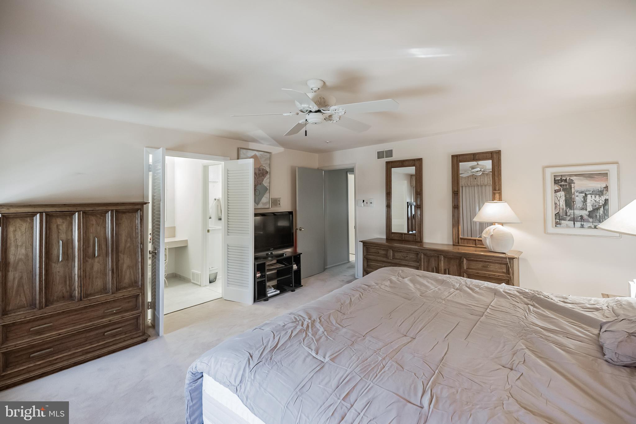 9659 Pine Road Philadelphia, PA 19115 - Photo 18 of 27 a bedroom with a bed and dresser with mirror