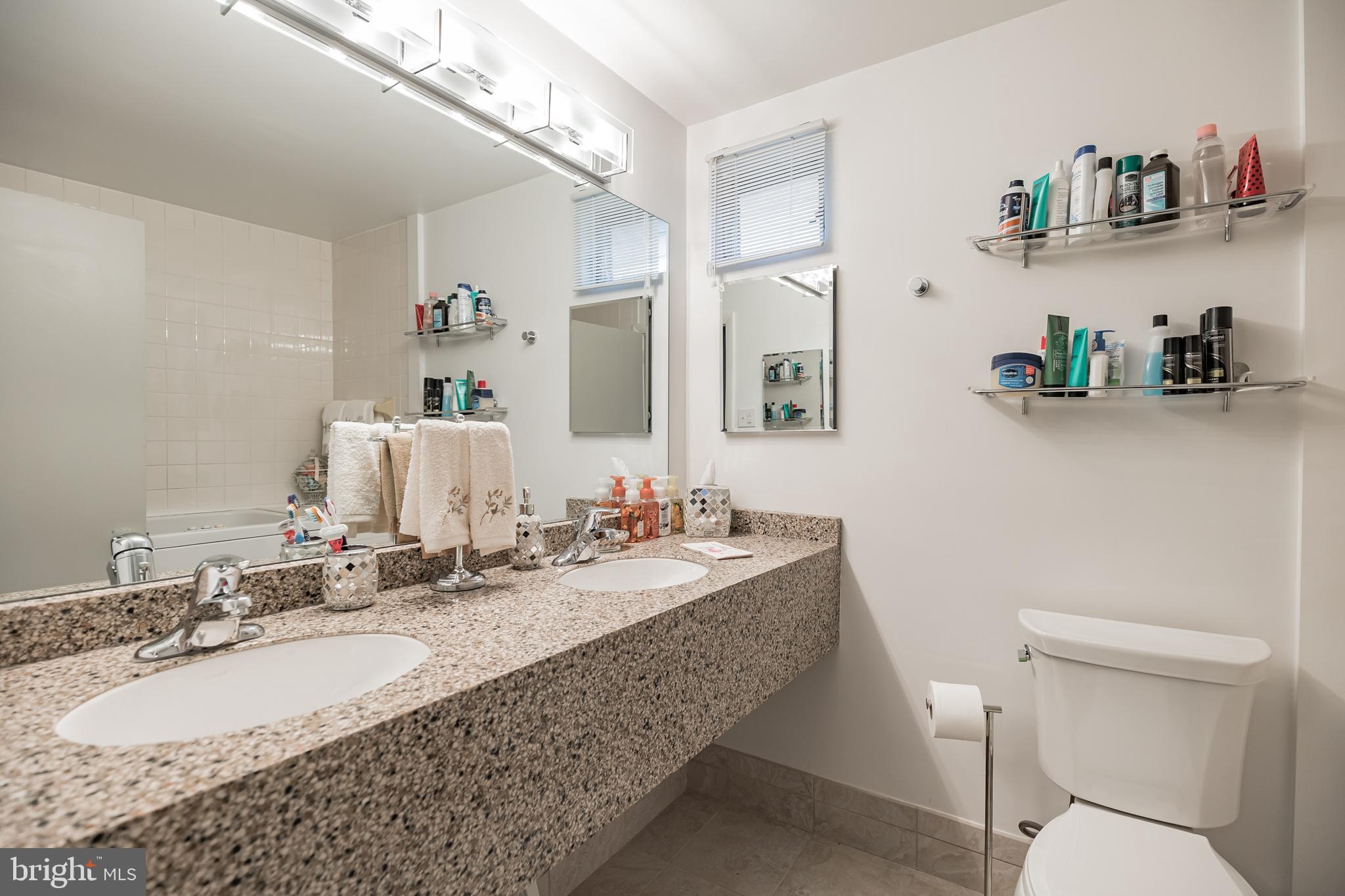 9659 Pine Road Philadelphia, PA 19115 - Photo 21 of 27 a bathroom with a granite countertop sink a toilet and a mirror