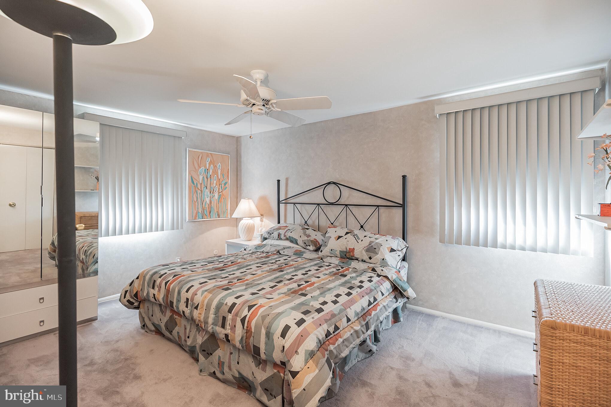 9659 Pine Road Philadelphia, PA 19115 - Photo 23 of 27 a bedroom with a bed and a chandelier
