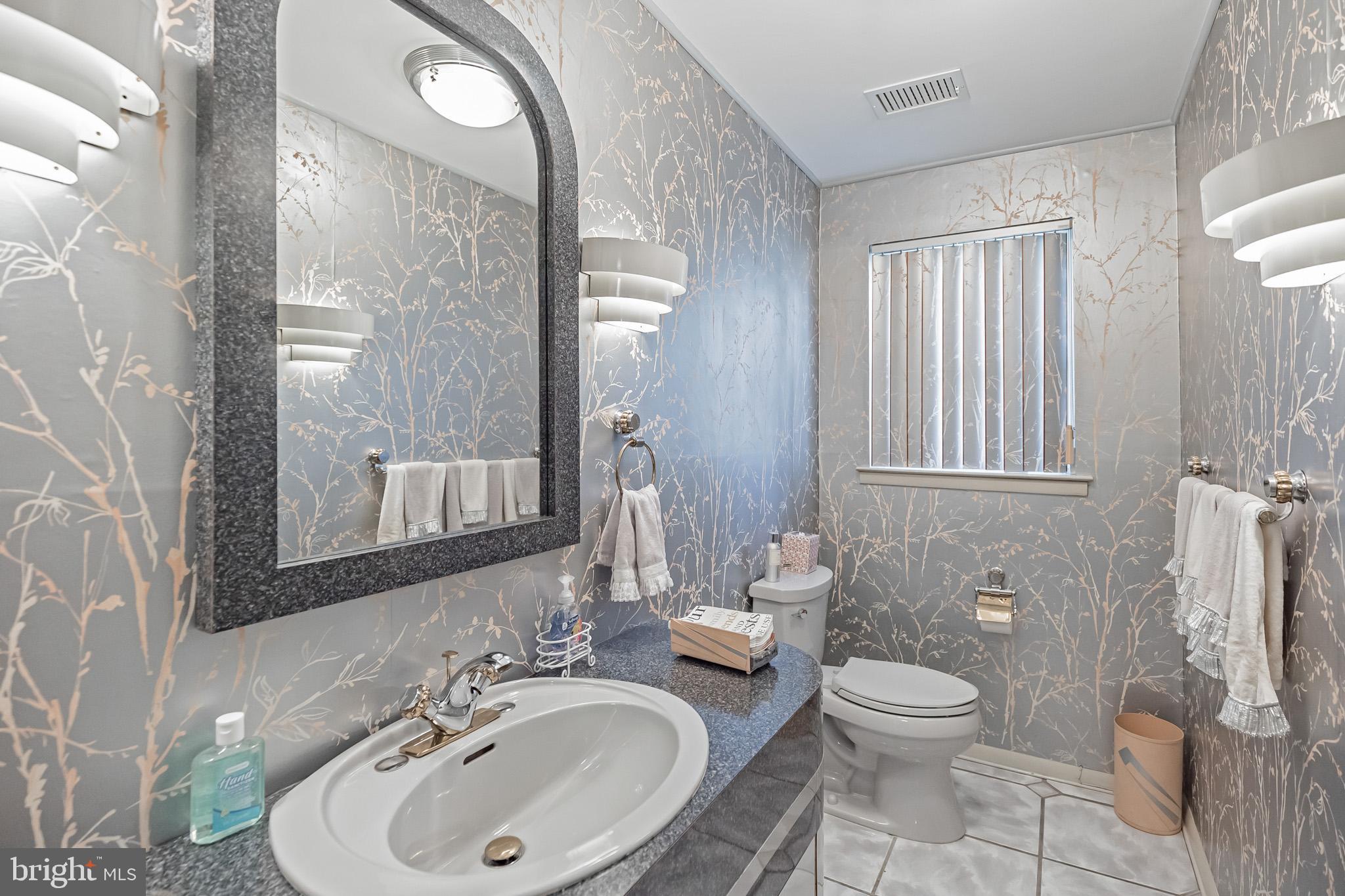 9659 Pine Road Philadelphia, PA 19115 - Photo 9 of 27 a bathroom with a toilet a sink and mirror