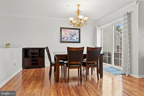 a view of a dining room with furniture wooden floor and chandelier
