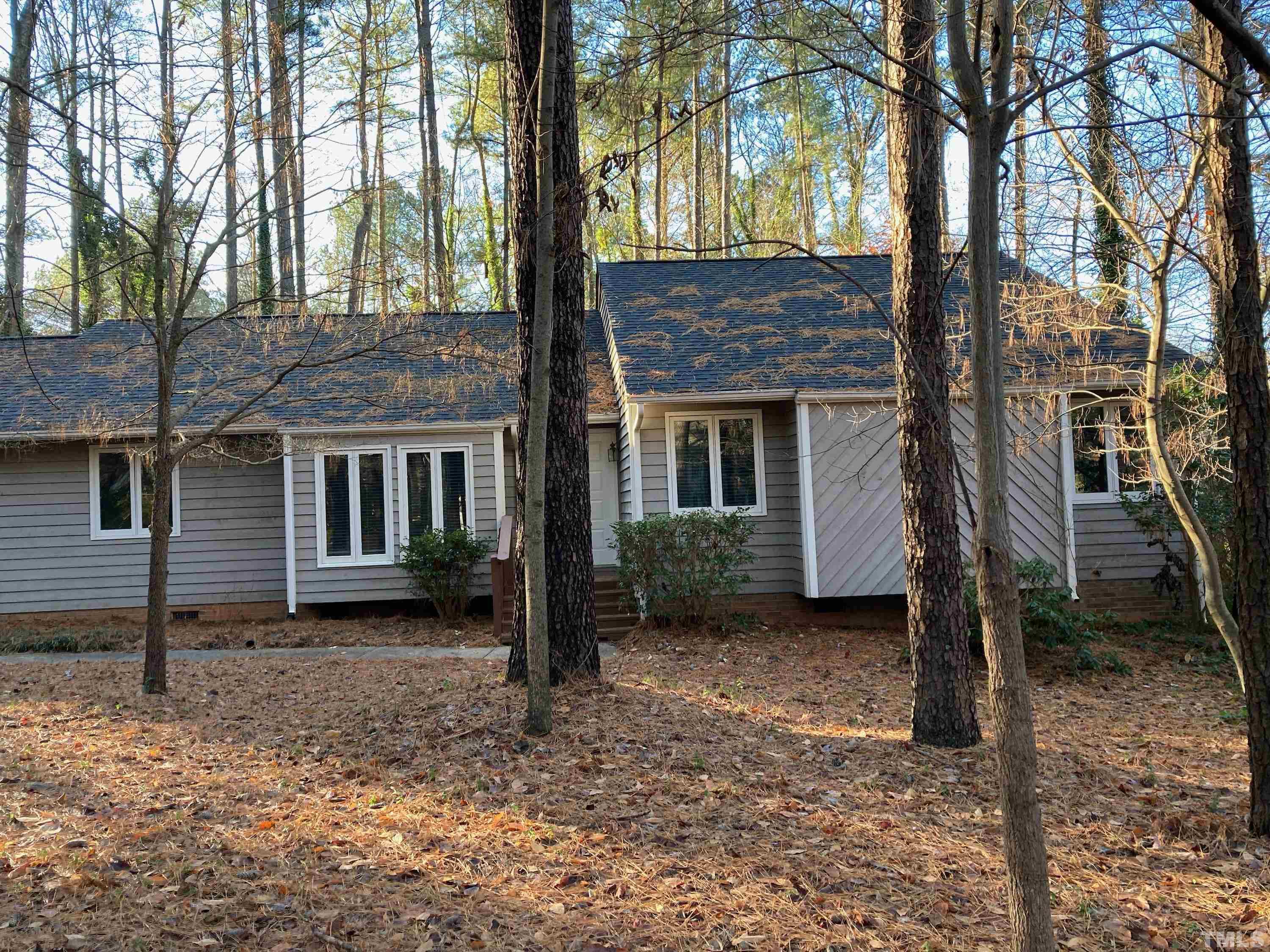 a view of a house with a tree in the yard