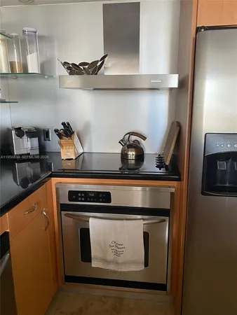a stove top oven sitting inside of a kitchen