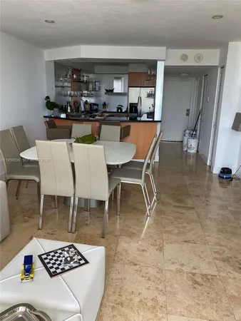 a dining room with a table and chairs