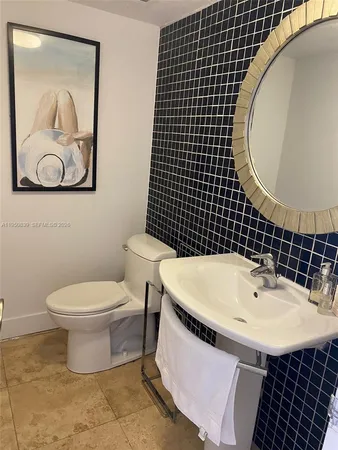 a bathroom with a sink toilet and mirror