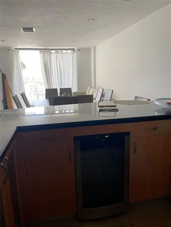 a kitchen with a sink and a wooden cabinets