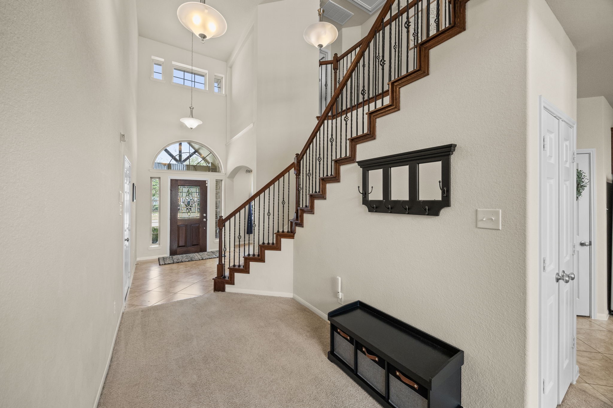 9402 Wheatfield Lane Rosenberg, TX 77469 - Photo 6 of 47 Gorgeous stairs with iron railing and warm-wood banister.