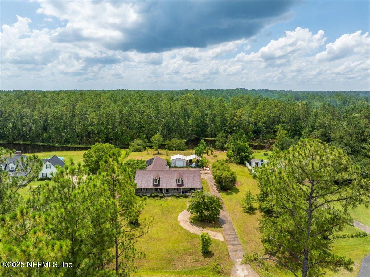 55056 Yellow Jacket Drive Callahan, FL 32011 - Photo 1 of 31 a aerial view of a house with a garden