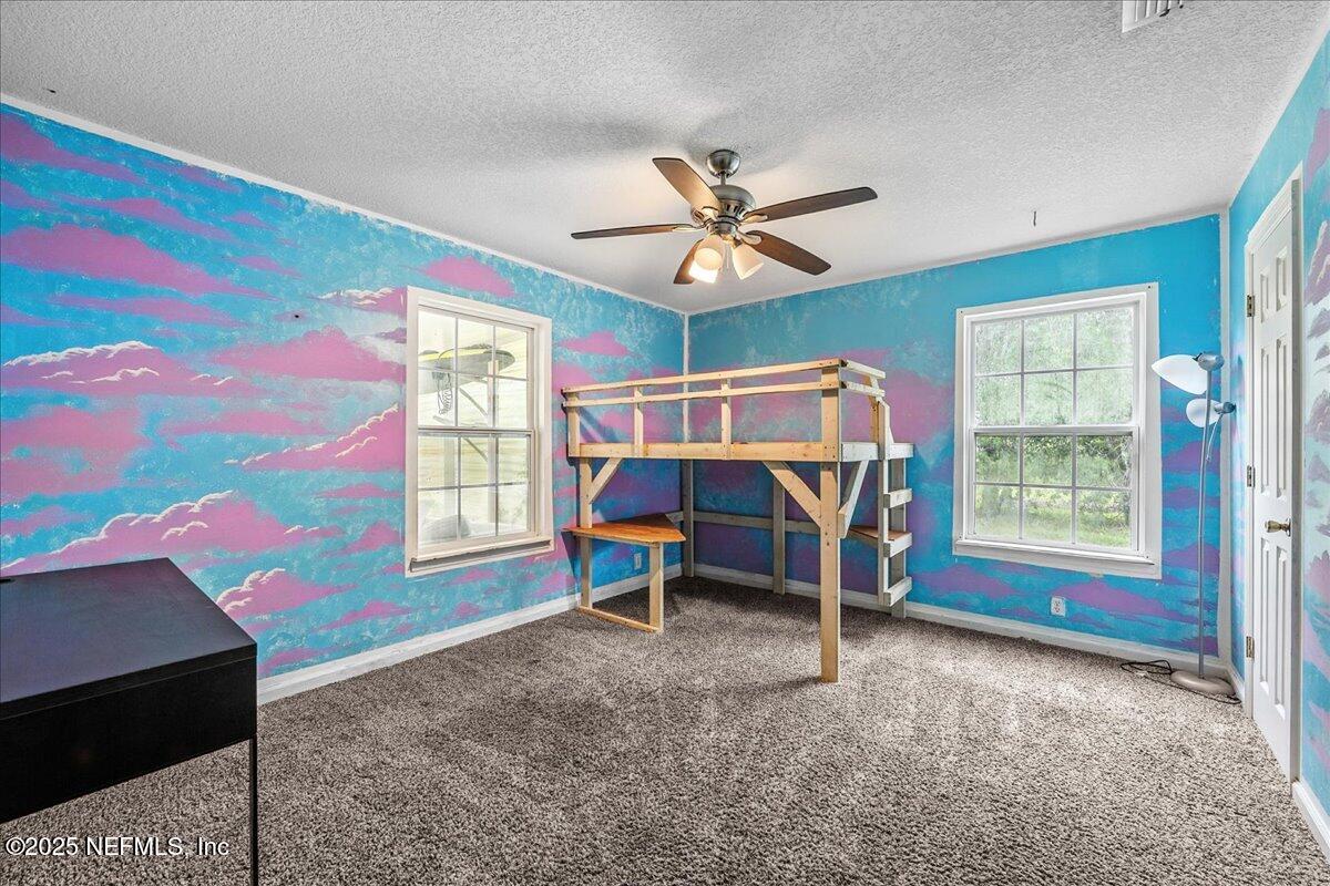 55056 Yellow Jacket Drive Callahan, FL 32011 - Photo 17 of 31 a view of a bedroom with window and furniture