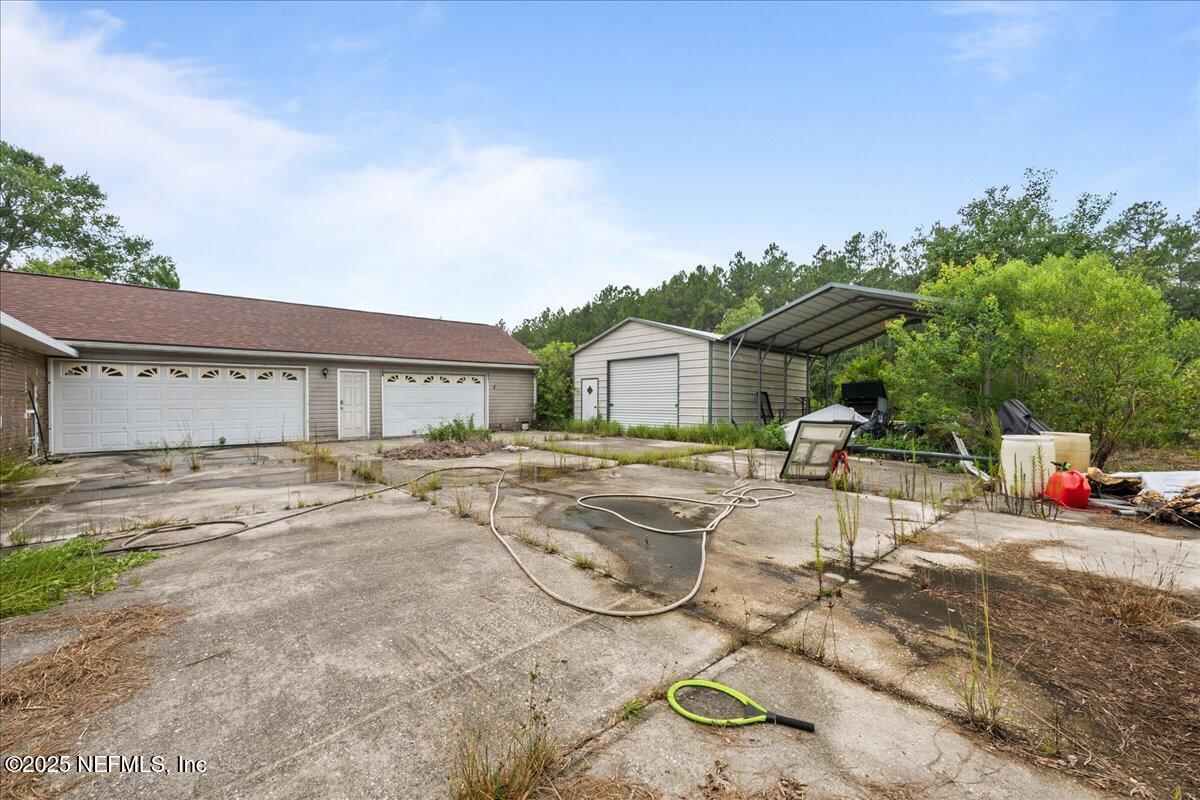 55056 Yellow Jacket Drive Callahan, FL 32011 - Photo 21 of 31 a front view of a house with garden